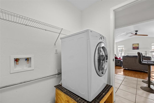 washroom with washer / clothes dryer, a ceiling fan, laundry area, and light tile patterned floors