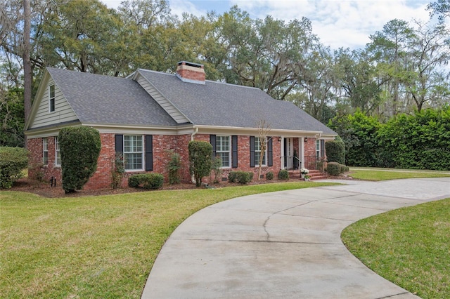 view of front of house with crawl space, a front lawn, and brick siding