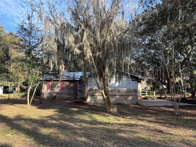 view of side of home featuring a yard