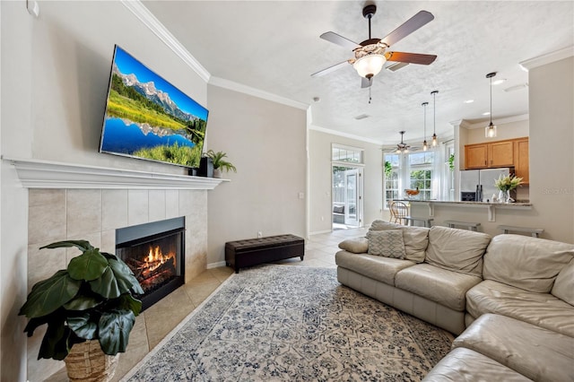 living room featuring light tile patterned floors, ornamental molding, and a fireplace