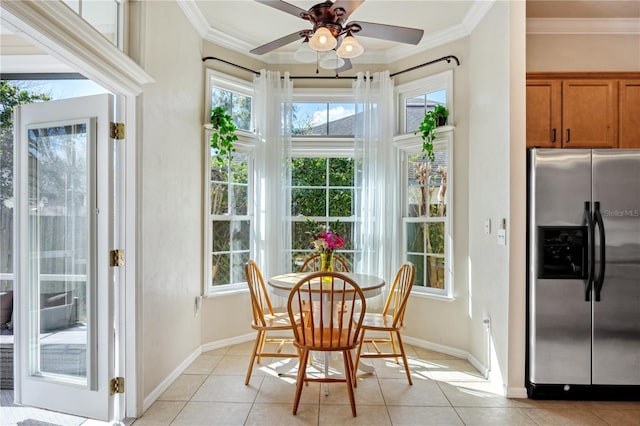 dining space with crown molding, baseboards, and light tile patterned floors