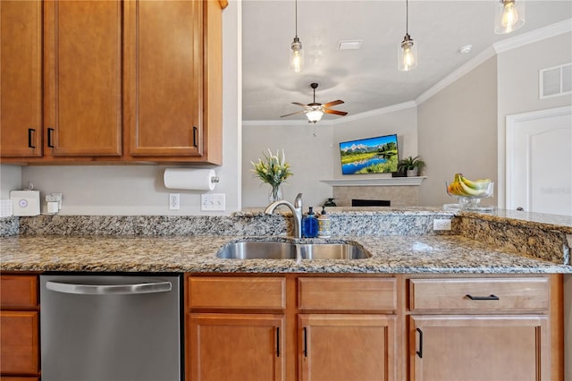 kitchen featuring visible vents, crown molding, stainless steel dishwasher, a fireplace, and a sink