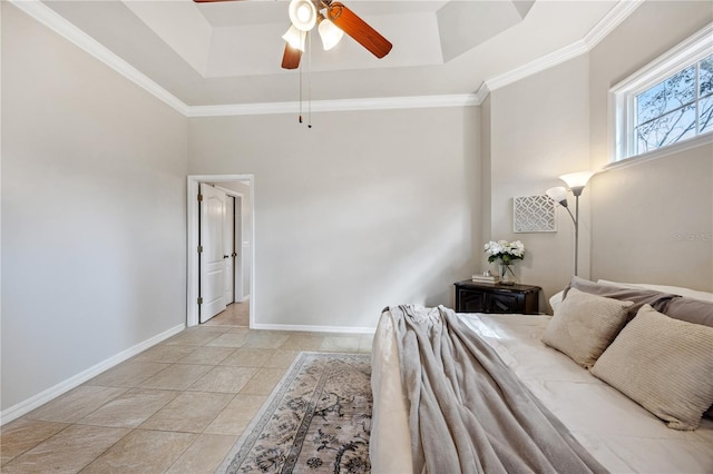 bedroom with light tile patterned floors, baseboards, a raised ceiling, ceiling fan, and crown molding