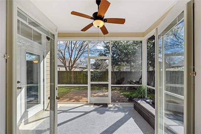 unfurnished sunroom with a ceiling fan