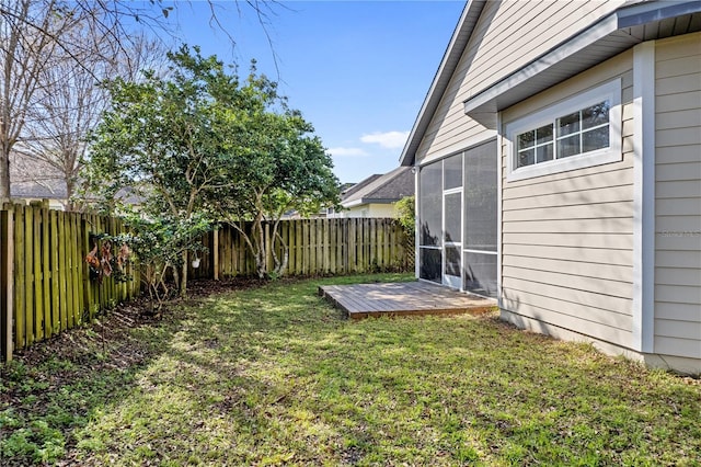 view of yard with a sunroom and a fenced backyard