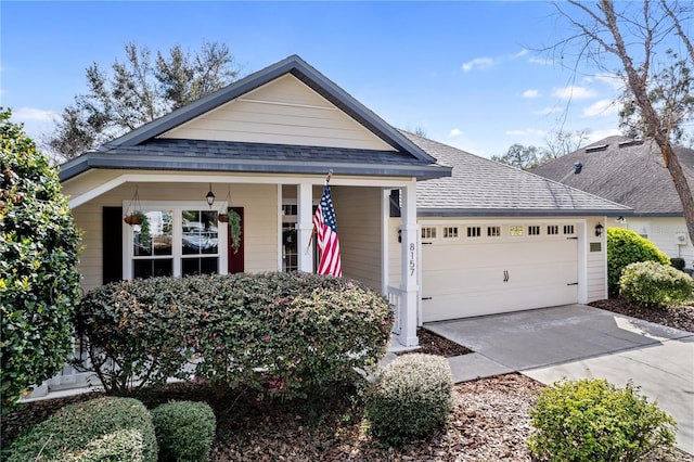 view of front of property featuring roof with shingles, driveway, and an attached garage