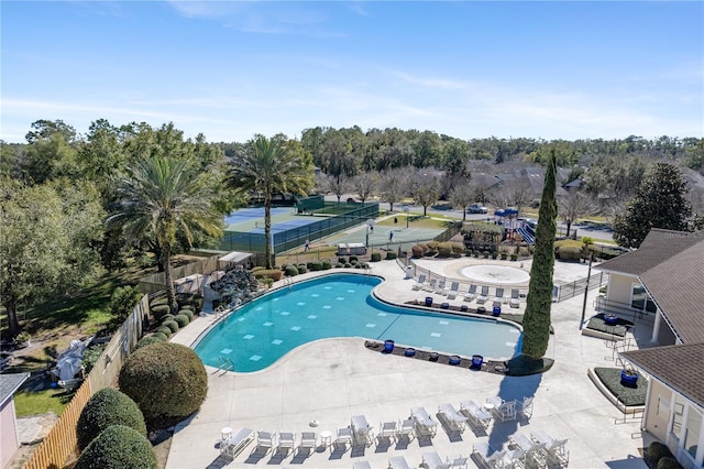 pool with fence and a patio