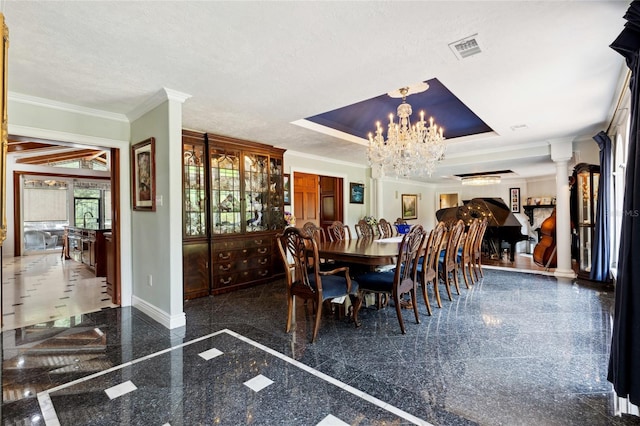 dining area featuring decorative columns, visible vents, granite finish floor, ornamental molding, and baseboards