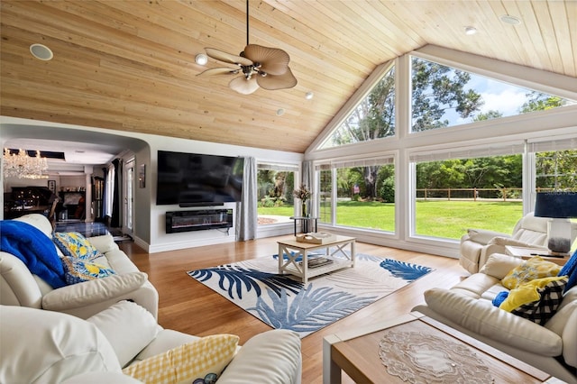 living room featuring wooden ceiling, high vaulted ceiling, a wealth of natural light, and wood finished floors