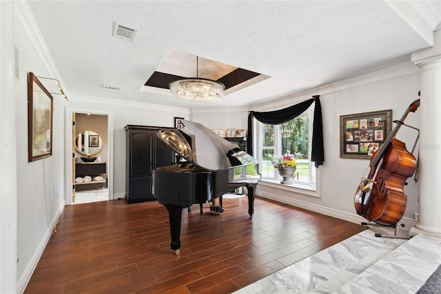 sitting room with crown molding, a tray ceiling, visible vents, and dark wood finished floors