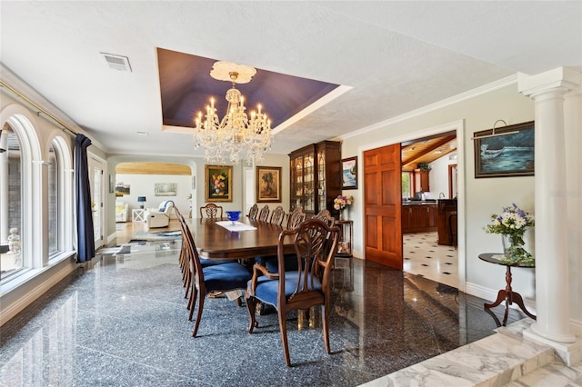 dining room with ornamental molding, granite finish floor, visible vents, and baseboards