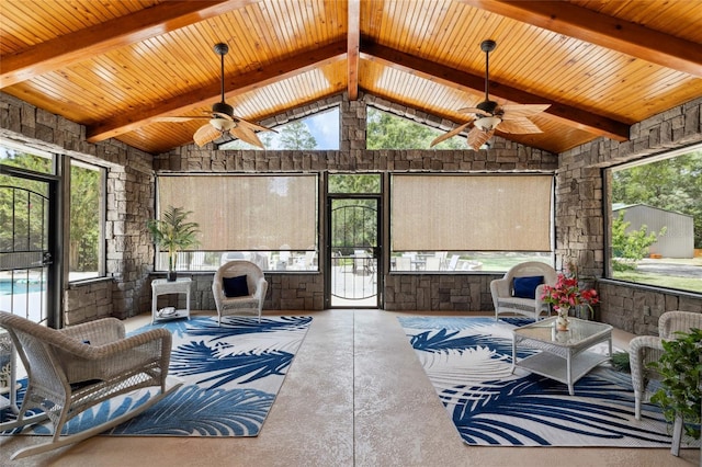 sunroom featuring a wealth of natural light, vaulted ceiling with beams, and ceiling fan