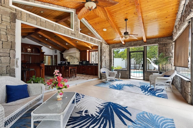 interior space featuring high vaulted ceiling, wooden ceiling, a sink, access to exterior, and beamed ceiling