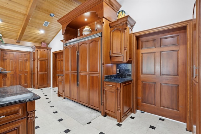 kitchen with lofted ceiling with beams, tasteful backsplash, wood ceiling, and brown cabinets