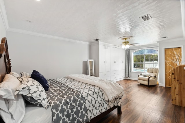 bedroom featuring ceiling fan, visible vents, dark wood finished floors, and crown molding