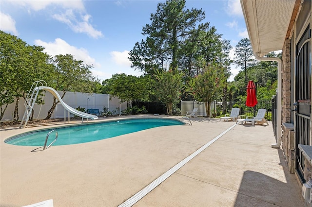 view of pool featuring a fenced in pool, a patio area, a water slide, and a fenced backyard