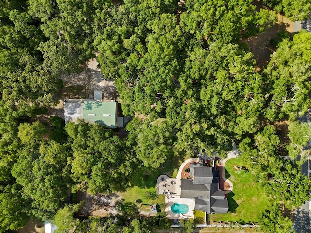 bird's eye view with a wooded view