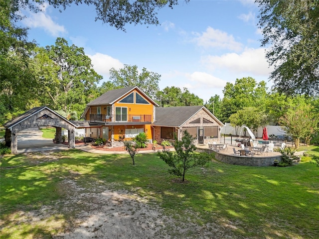 view of front of house with a front lawn and a patio area