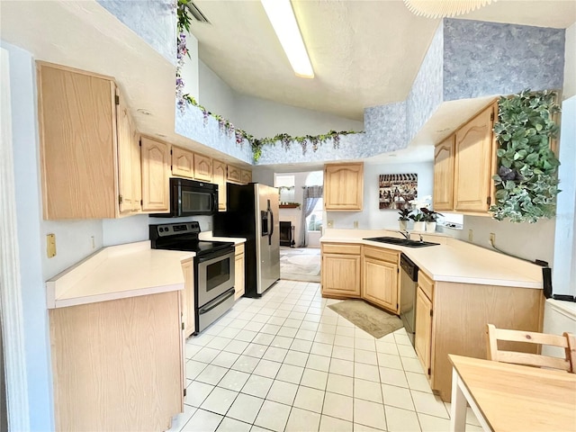 kitchen featuring a sink, stainless steel appliances, light brown cabinetry, and light countertops