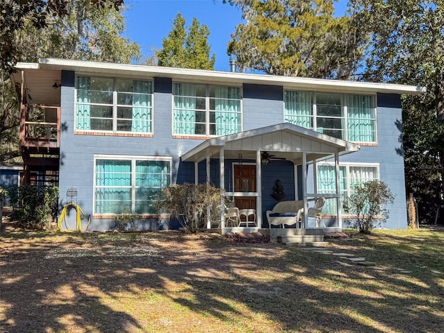 view of front of home featuring concrete block siding and a ceiling fan