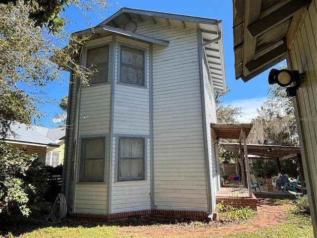 view of side of home with a patio area