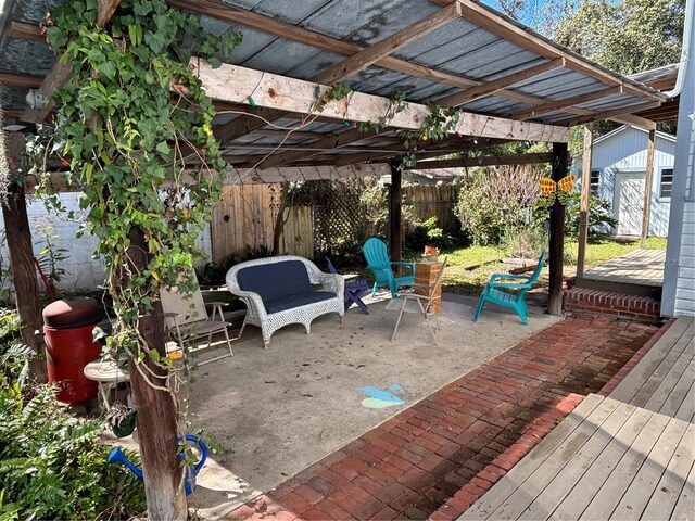 view of patio / terrace with an outdoor structure, a fenced backyard, a pergola, and a deck