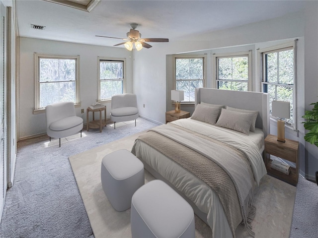 bedroom with baseboards, ceiling fan, light colored carpet, and visible vents