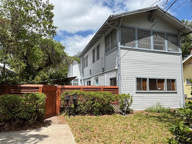 view of property exterior featuring fence and a yard