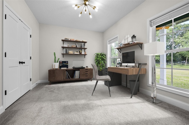 office space with baseboards, a textured ceiling, carpet flooring, and an inviting chandelier