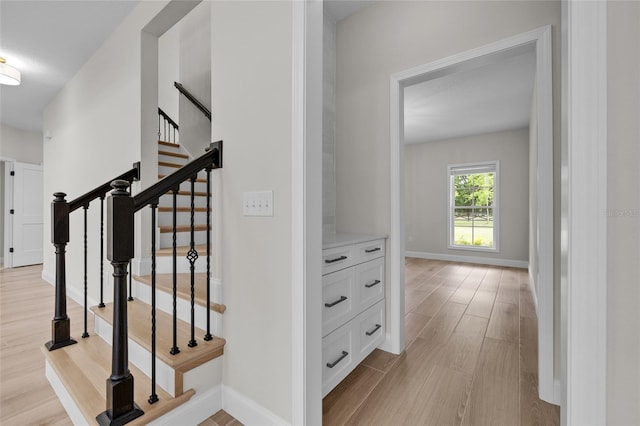 stairs featuring baseboards and wood finished floors