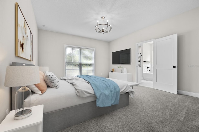 carpeted bedroom featuring connected bathroom, a notable chandelier, a textured ceiling, and baseboards