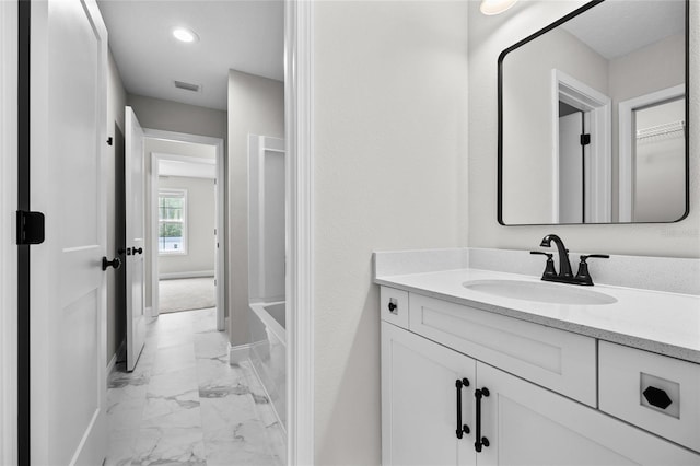 bathroom with recessed lighting, marble finish floor, vanity, and baseboards