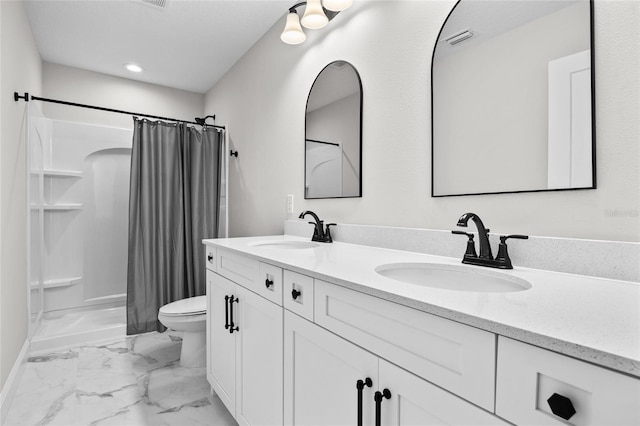 full bathroom featuring toilet, marble finish floor, visible vents, and a sink