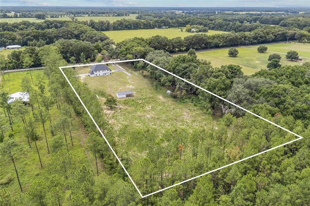 drone / aerial view with a rural view and a wooded view