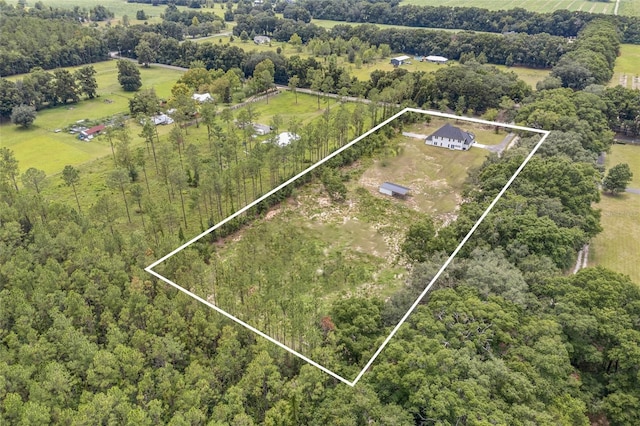 birds eye view of property with a rural view