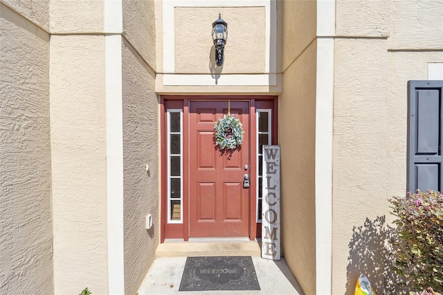 doorway to property with stucco siding