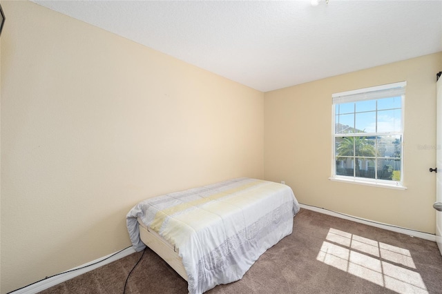 carpeted bedroom featuring baseboards