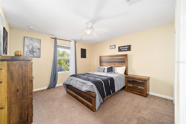 bedroom featuring baseboards, ceiling fan, visible vents, and light colored carpet