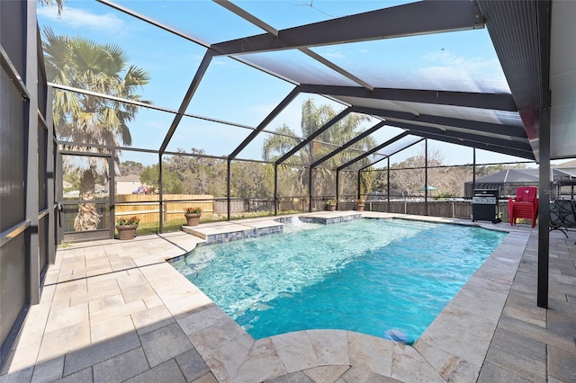 outdoor pool with area for grilling, a patio area, and a lanai