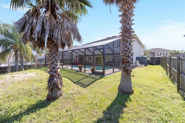 view of yard featuring glass enclosure, central AC, a fenced backyard, and a fenced in pool