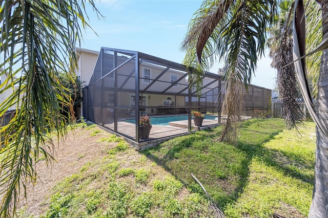 pool with glass enclosure and a yard