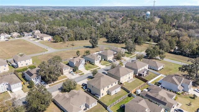 birds eye view of property with a residential view and a view of trees