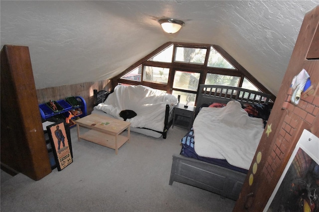 carpeted bedroom featuring lofted ceiling and a textured ceiling