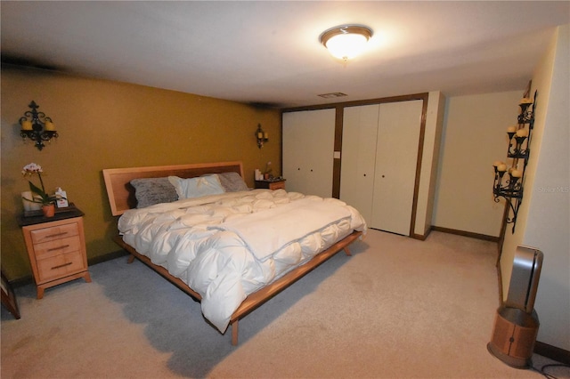 bedroom featuring light carpet and visible vents