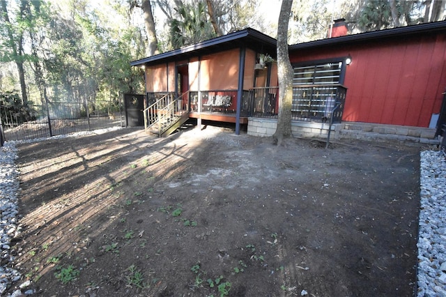 exterior space featuring a chimney and fence