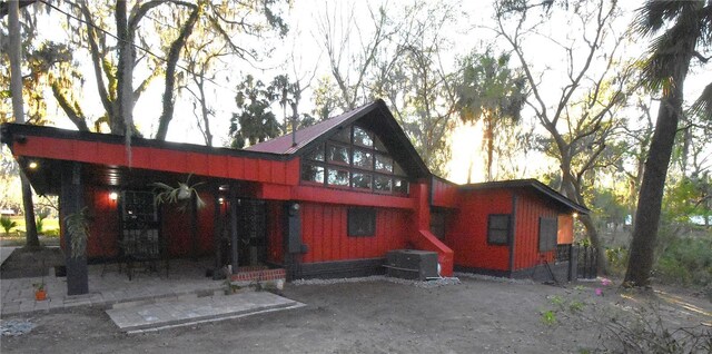 rear view of property featuring cooling unit and a patio