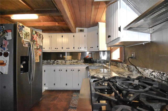 kitchen featuring stainless steel fridge with ice dispenser, wooden ceiling, wall chimney range hood, white cabinetry, and a sink