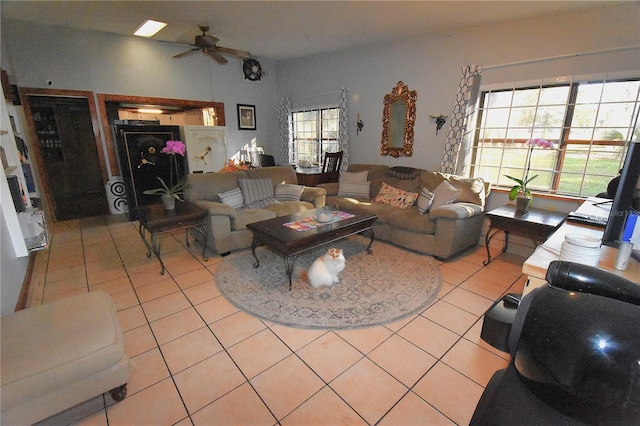 living area with a ceiling fan and light tile patterned flooring