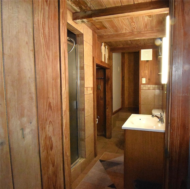 full bath with a stall shower, wooden walls, wood ceiling, vanity, and tile walls