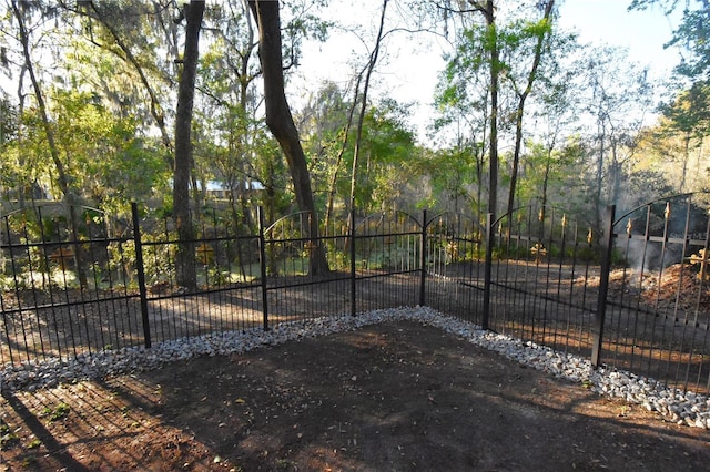 view of gate with fence